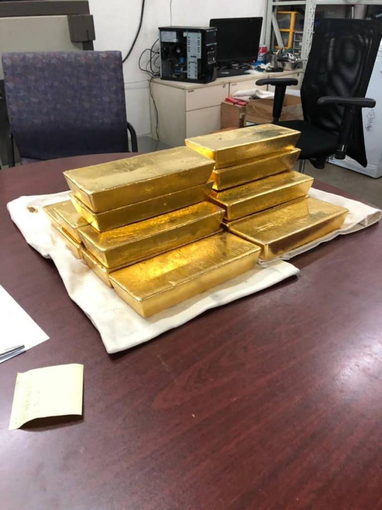 Refined gold bars arranged on a table